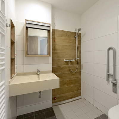 Barrierefreier Badbereich der Palliativstation mit ebenerdiger Dusche, modernem Waschtisch und Spiegel mit Holzrahmen.