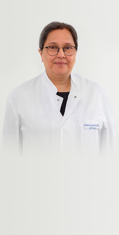 Porträtbild von Chefärztin Dr. med. Gök-Manay auf grauem Hintergrund.
